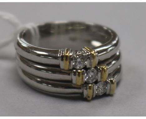 A modern 18ct white gold and diamond triple band ring, size O.