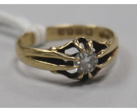 An early 20th century 18ct gold and claw set solitaire diamond ring, size O.