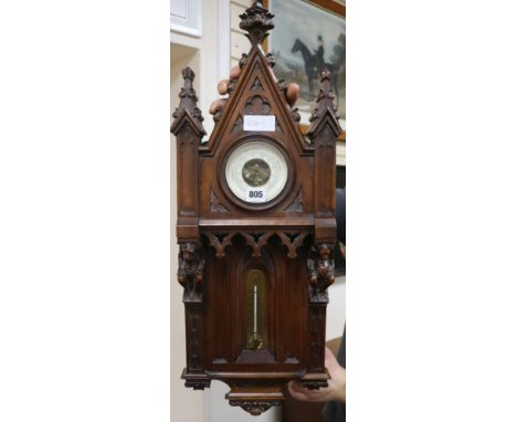 A late 18th century French gothic design carved walnut aneroid barometer and thermometer H.76cm