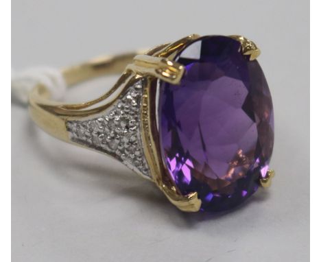 A modern 9ct gold, amethyst dress ring with diamond set shoulders, size N.