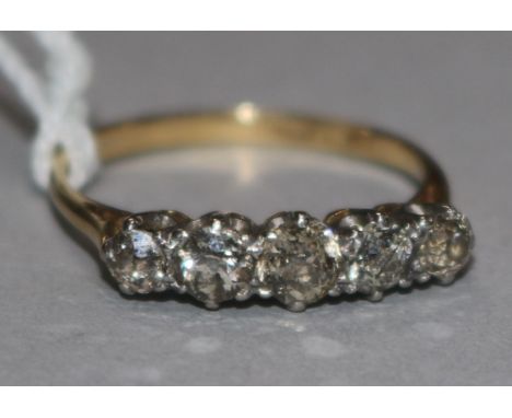 A gold and platinum five stone diamond half hoop ring, size P.