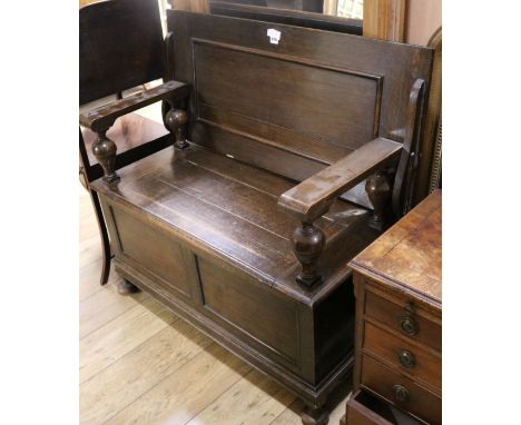 A 1930's oak monk's bench, W.107cm