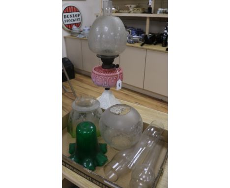 A Victorian oil lamp and shades