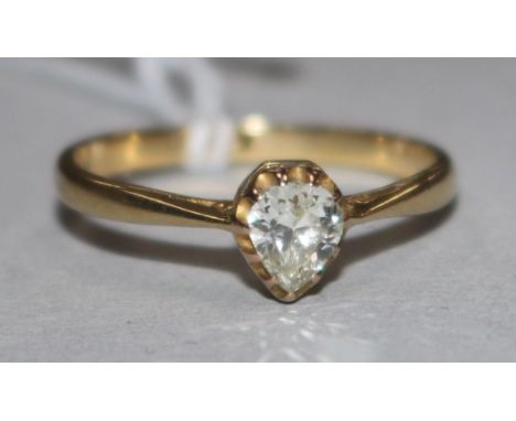 An 18ct gold and solitaire pear shaped diamond ring, size N.