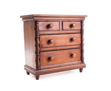 A Victorian pitch pine miniature chest of drawers, fitted two short over two long drawers flanked by split bobbin pilasters, 