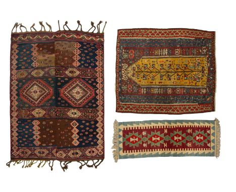 An old indigo blue ground Persian Kelim comprised of two joined panels with hooked diamond motif with gathered fringes at eac