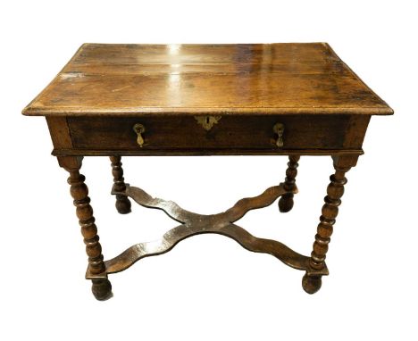 A William and Mary single drawer side table with bobbin and fillet legs united by a shaped stretcher and on onion-shaped feet