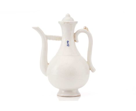 A Chinese Qinbai-style porcelain wine ewer and cover of baluster form with anhua fruiting peach tree decoration, fitted a swa