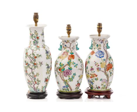 A pair of Chinese Famile rose porcelain baluster vase form table lamps, 20th century, painted with colourful flowering prunus