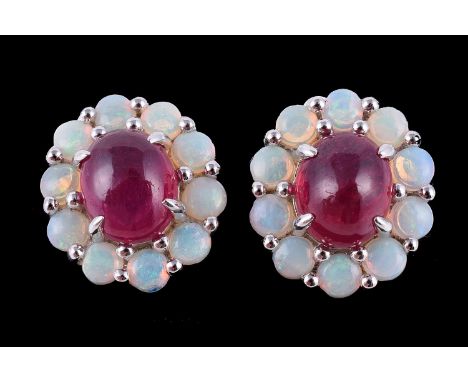 A pair of opal and ruby cluster earrings, each with a central oval cabochon ruby within a surround of circular cabochon opals