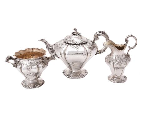 Y A William IV silver three piece lobed circular tea set by Charles Fox II, London 1835, the tea pot with a foliate finial to