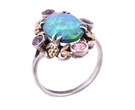 An Arts and Crafts opal doublet and pink tourmaline dress ring in the manner of Bernard Instone, circa 1930, the oval cabocho