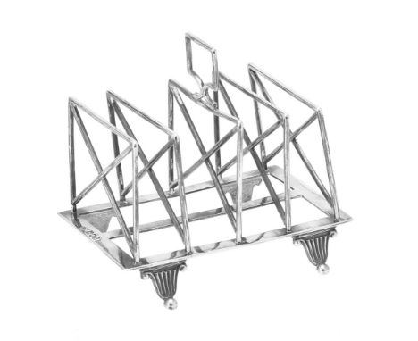 An Edwardian silver four division toast rack by William Hutton & Sons, London 1902, with a loop handle and on four ball feet,
