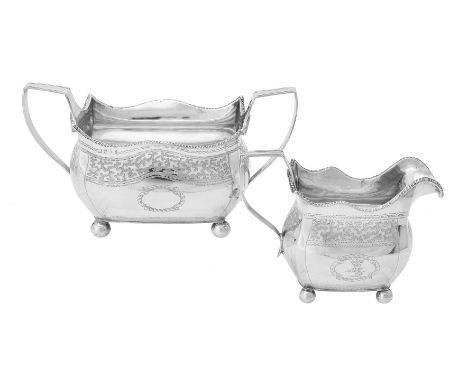 A George III Irish silver oblong baluster sugar bowl and cream jug, no maker's marks, Dublin 1809, sugar bowl with twin harp 