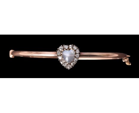 A late Victorian diamond and moonstone hinged bangle, circa 1890, the heart shaped cabochon moonstone claw set within a surro