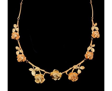 A French gold coloured rose necklace, the necklace with naturalistic textured rose flower head and leaf panels, to a baton li