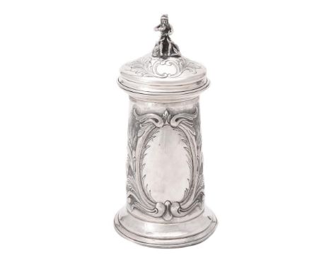 A continental silver tankard, early 20th century, stamped K. Inceian 900, with a seated figure finial to the foliate chased d