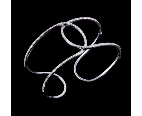 A diamond hinged bangle, the pierced crossover bands set with brilliant cut diamonds, approximately 0.90 carats total, with s