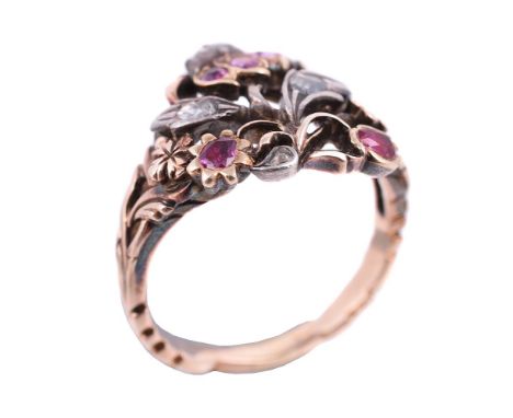 An early 20th century ruby and diamond giardinetti ring, the pierced panel with a rose cut diamond and cushion cut ruby flowe