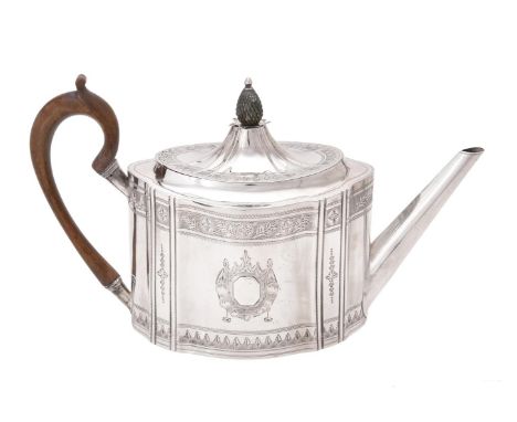 A George III Irish silver shaped oval tea pot, Dublin circa 1769, with a pineapple finial to the domed cover, a wooden loop h