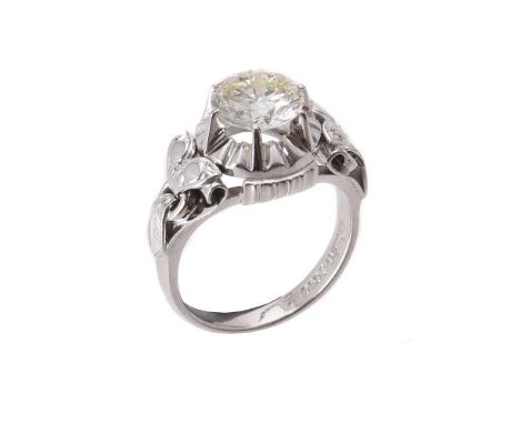 A single stone diamond ring, the brilliant cut diamond weighing 2.13 carats in a raised claw setting, to polished leaf accent