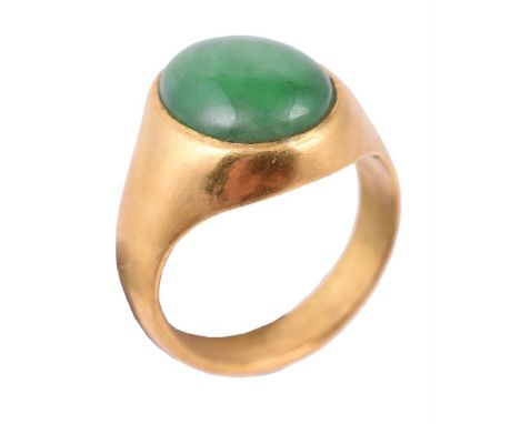 A jadeite jade dress ring, the oval jadeite jade panel within a gold coloured setting, with Chinese marks, finger size K 1/2,