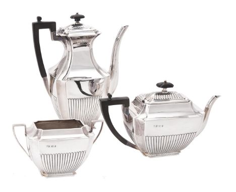 A late Victorian silver three piece half gadrooned tea and coffee set by Atkin Brothers, Sheffield 1897, the tea pot with a w