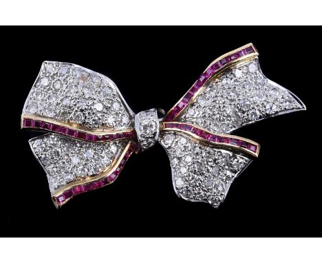 A ruby and diamond bow brooch, the crossover tapered panels pavé set with eight cut diamonds, approximately 1.00 carat total,