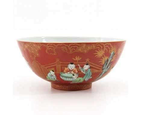 Orange ground with Famille Rose and gilt decor depicting children playing in garden, Jiaqing mark, 21 cm. in diameter. 