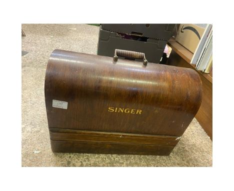 An Early-Mid 20th Century Singer Sewing machine in Original Wood Case. Key missing and it is currently locked.