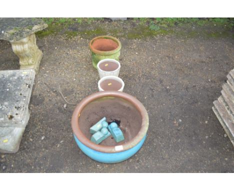 A large blue glazed planter together with three others 