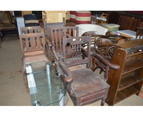 A spindle back carver chair; a slate back commode chair and a brown leather carver chair