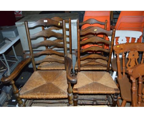 Four oak ladder back dining chairs to include one carver