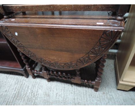 A mid 20th Century oak Old Charm style twist gate leg dining table