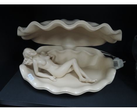 A resin shell lamp modelled as a naked woman