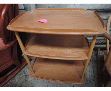 An Ercol elm three tier trolley table