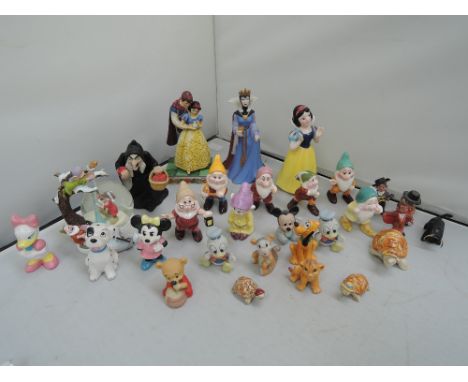 A selection of Walt Disney ceramic figures and decorative ornaments, Snow White and the Seven Dwarves, Mickey Mouse etc