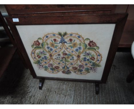 A mid 20th century oak frame firescreen having tapestry inset