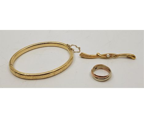 A 14ct. gold hinged bangle, scroll engraved to exterior, internal measurement 63mm x 52mm (14.9g), together with a 14ct. gold