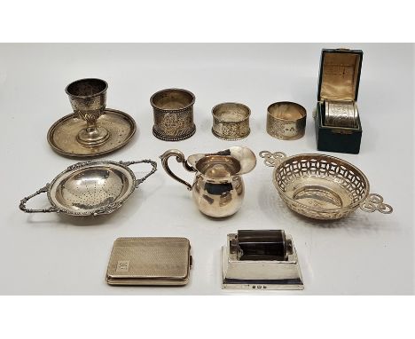 Two silver circular twin handled tea strainers, one by Synyer &amp; Beddoes, Birmingham 1912, the other by Charles S Green &a