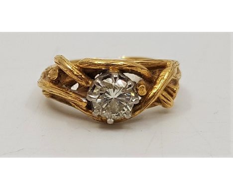 An 18ct. gold diamond solitaire ring, claw set round brilliant cut diamond (diamond weight approx. 0.45 carats), with texture