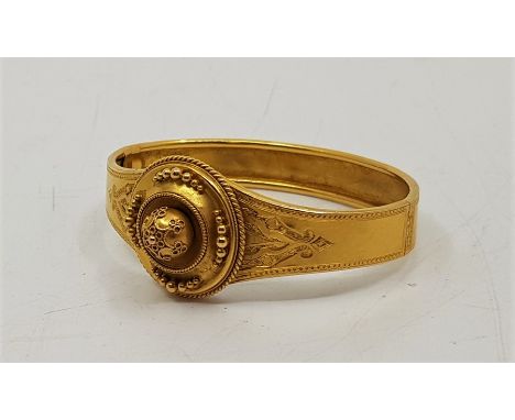 A 19th century precious yellow metal hinged mourning bangle, the front having fine wire work decorated disc to centre with en
