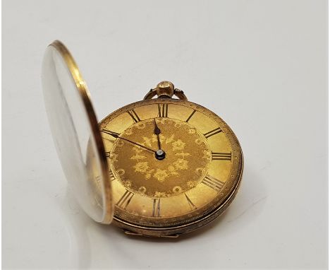 A precious yellow metal open face pocket watch, key wind, having engraved and engine turned dial with Roman numeral chapter r