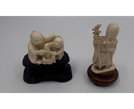 Two early 20th Japnese carved Ivory Netsuke figures with original wooden stands&nbsp;