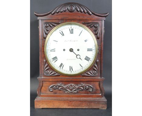 A 19th Century rosewood table bracket clock by James Condliff of Liverpool. The carved rosewood case having an arched pedimen