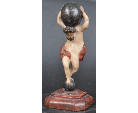 A 19th Century hand carved wooden figurine depicting the Greek God Atlas. Carved in the traditional depiction holding globe a