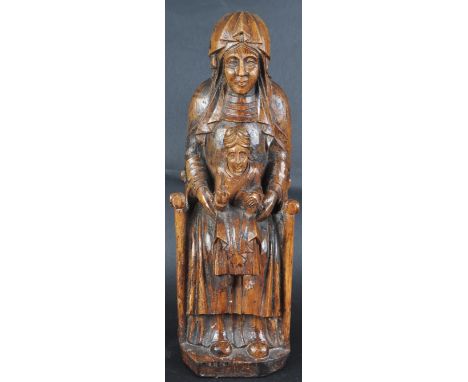 An 18th Century carved walnut religious ecclesiastical figurine depicting the Enthroned Virgin with child Christ seated on he