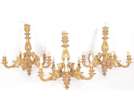 Three 19th century giltwood five branch chandeliers, the scrolling swan neck arms surround a fluted baluster stem with floral