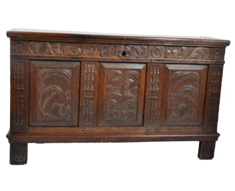 A large 19th Century carved oak trunk / storage chest having a domed hinged lid opening to reveal a hollow interior. Panel fr