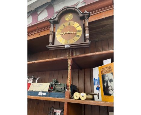 A Hermle wall clock with weights and pendulum. 